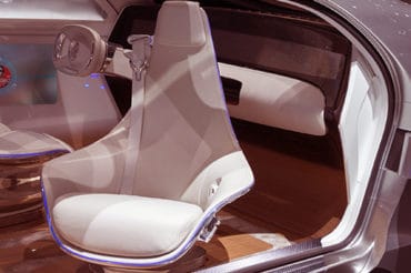 The door to a driverless vehicle opens to reveal a pivoting seat.