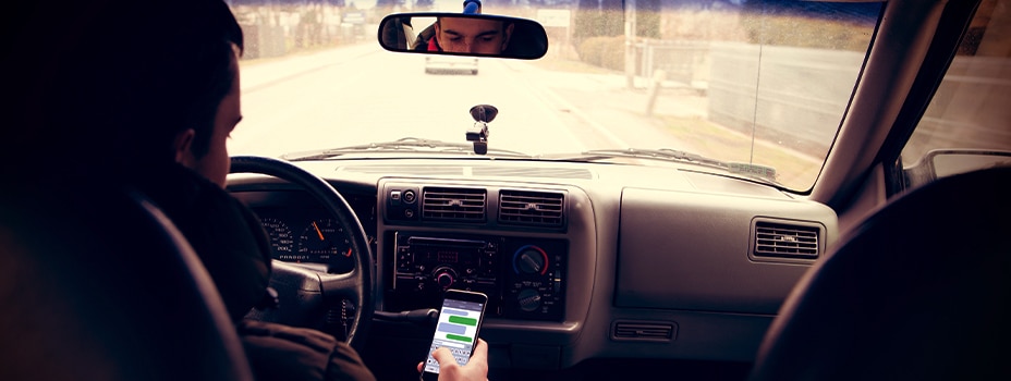 A man texts while driving.